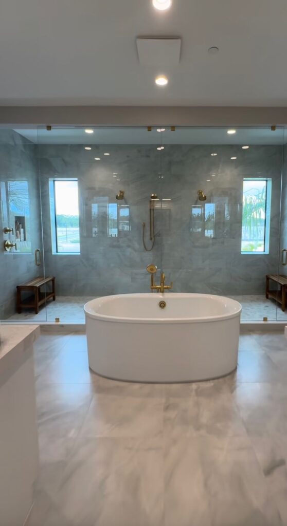 Luxury primary bathroom with a freestanding tub and glass shower