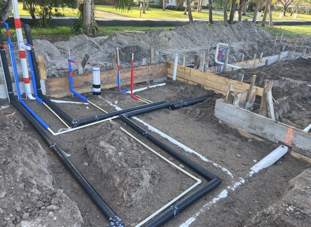 Underground plumbing rough in for a new construction foundation