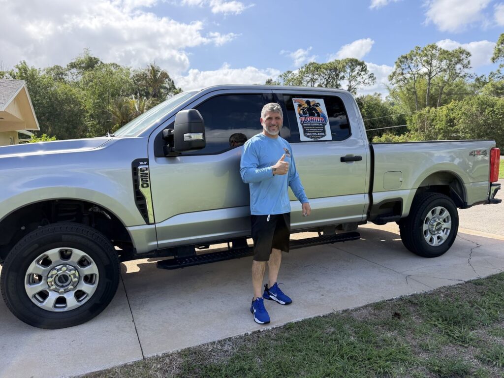 Florida Master Plumbing plumber beside the service truck