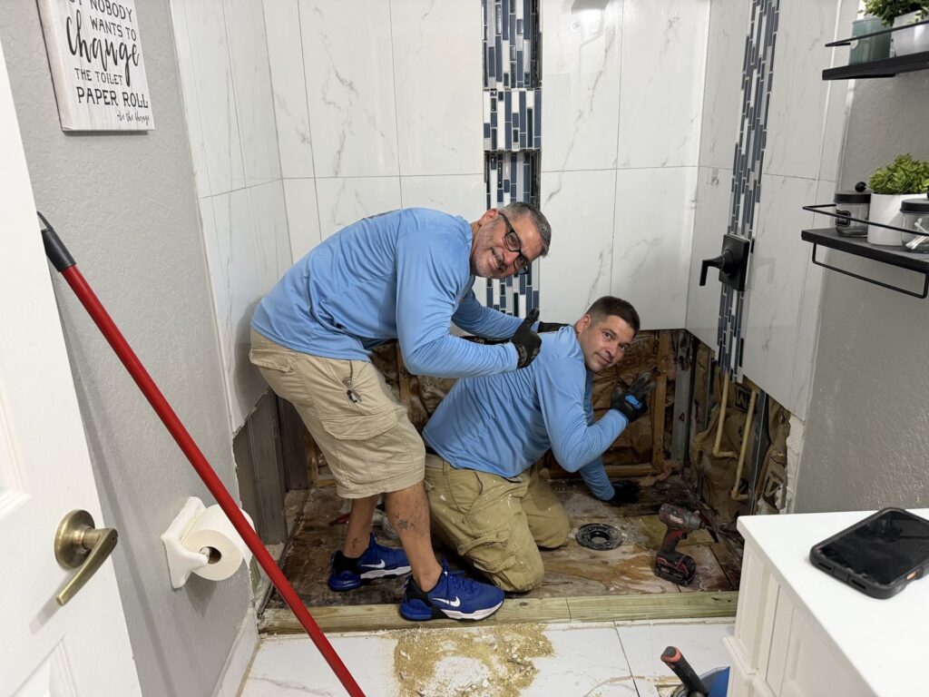 Florida Master Plumbing team repairing a bathroom leak