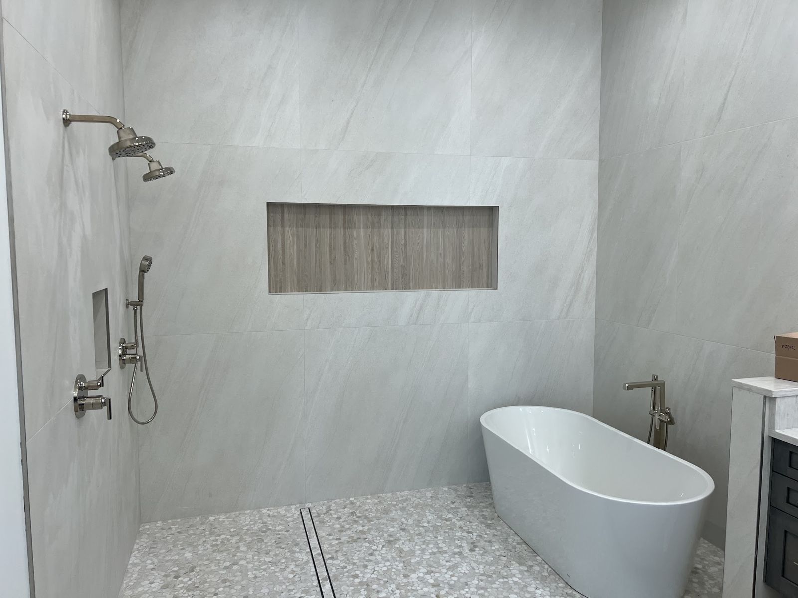 Remodeled bathroom with a walk in shower and freestanding tub